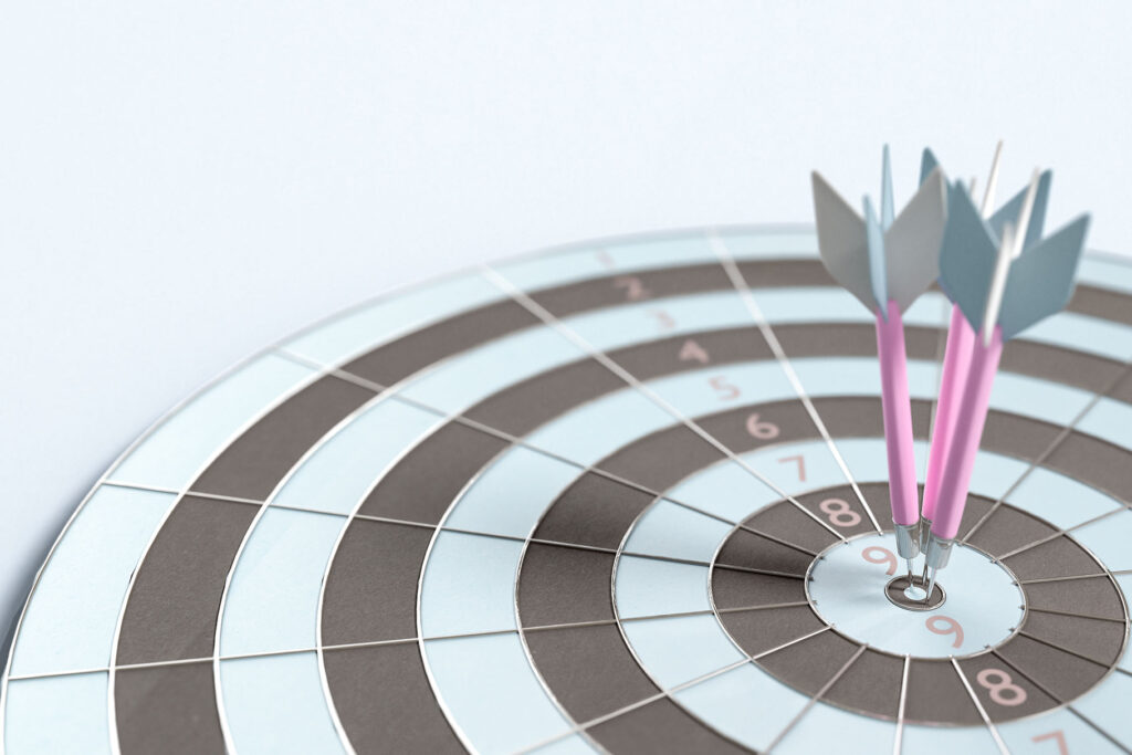 close-up-darts-stuck-board-against-white-background