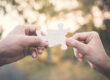 hand-holding-model-house-bokeh-background